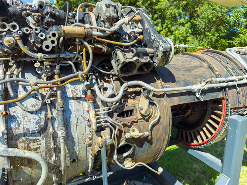 Obraz na plátně Engine parts displayed outside in a park during daytime under clear skies