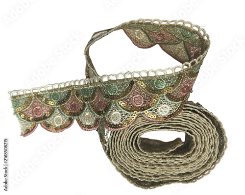Rolled vintage embroidered scalloped lace ribbon on transparent backdrop
