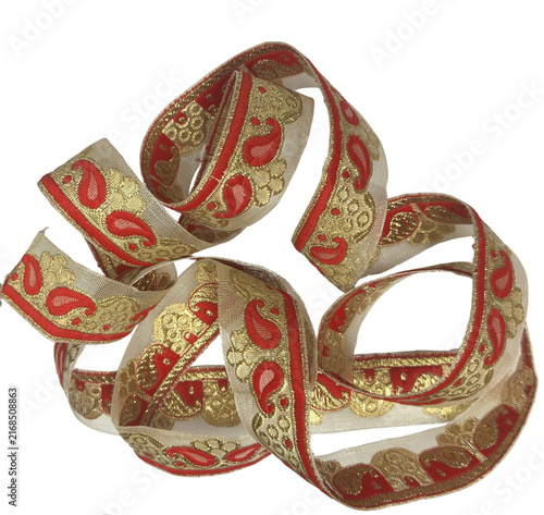 Uncoiled traditional red and gold paisley printed border ribbon cutout
