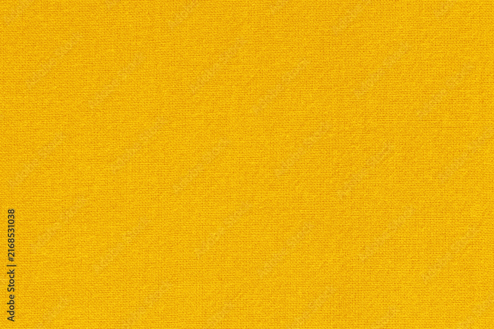 Naklejka premium Yellow gold cotton fabric cloth texture for background, natural textile pattern.