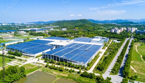 Aerial view of modern sports stadium with surrounding greenery.