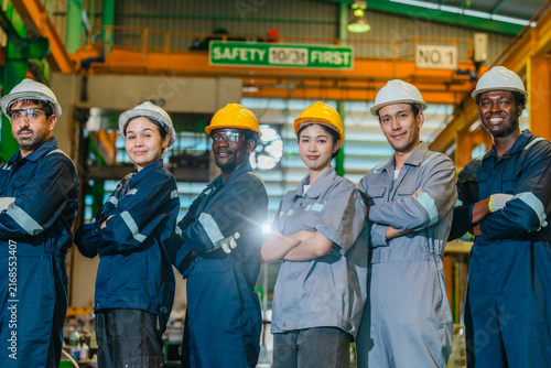 Confident production team showing approval in manufacturing facility