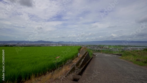 Descending Mountain Road with Rice Fields Overlooking Omura City and Bay in Nagasaki, Japan
