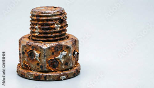 Heavily corroded steel flange bolt with flaking rust macro 