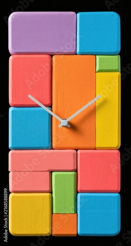 Colorful geometric blocks form a unique, modern wall clock design