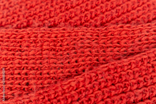 Close-up view of red knitted fabric showing texture and pattern details