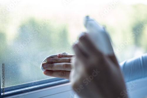 Cleaning a window on a sunny day at home to improve view and light
