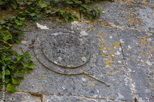 A symbol carved into the stone in an ancient city in the mountains. Termessos is an ancient city located in Turkey. Erosion on the stone. Traces of an ancient civilization.