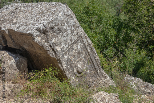 A symbol carved into the stone in an ancient city in the mountains. Termessos is an ancient city located in Turkey. Erosion on the stone. Traces of an ancient civilization.