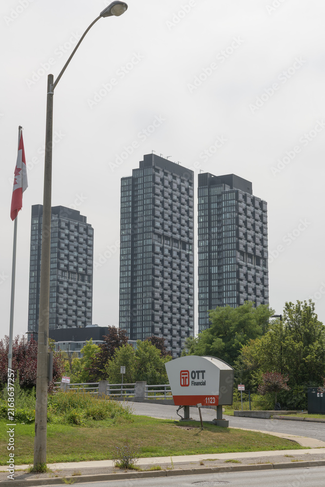 Naklejka premium sign outside driveway to OTT Financial Group (1123 Leslie St) with view of 1 crosstown condo, North York, Toronto