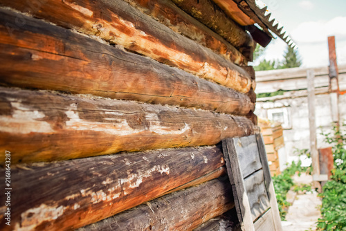 Quadro su tela Weathered log wall of an old wooden countryside house with natural wood texture