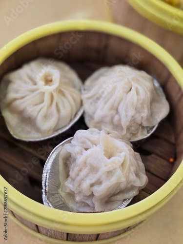 Fotografie Three steamed soup dumplings in bamboo traditional food preparation