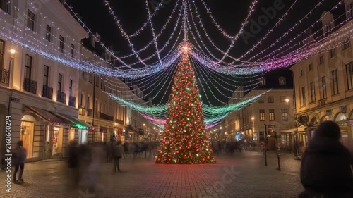 Festive Christmas Tree Lights Up City Square at Night.