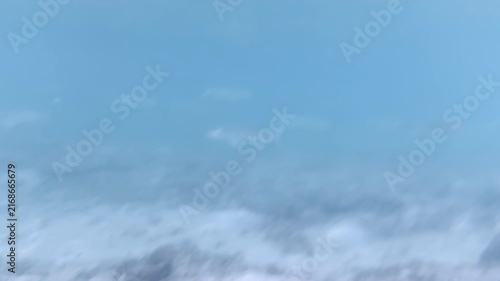 Horizontal underwater scene with distant blurred fish over rocky seabed, 4K