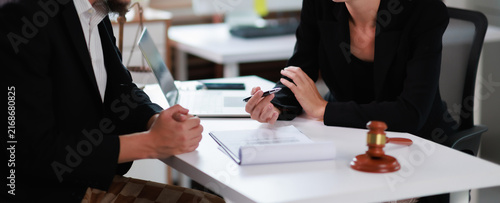 Legal professional consulting with a client  discussing contract details and providing expert advice in a modern office setting