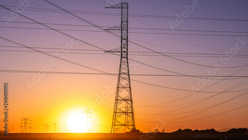 Power Grid Expansion Across Industrial Landscape at Dusk