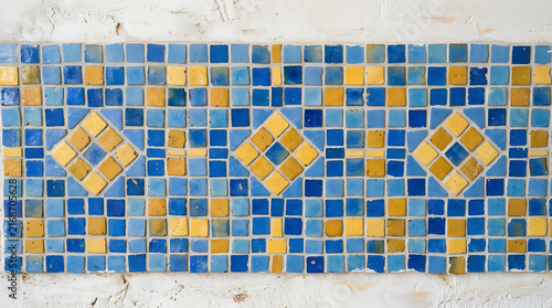 Intricate blue and yellow handcrafted ceramic tile mosaic pattern with geometric diamond accent