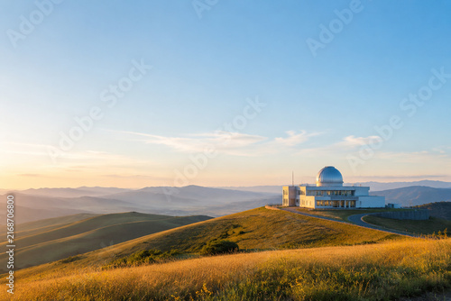 Modern observatory building in rolling hills landscape under clear sky, science and research concept