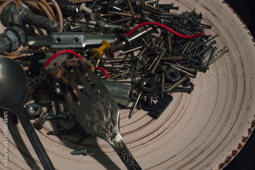 Canvastavla Close up conceptual abstract still life of plate with metal screws bolts red wir
