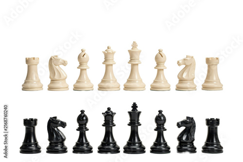 Full set of staunton chess pieces in contrasting black and white plastic arranged in two horizontal rows isolated on a transparent background