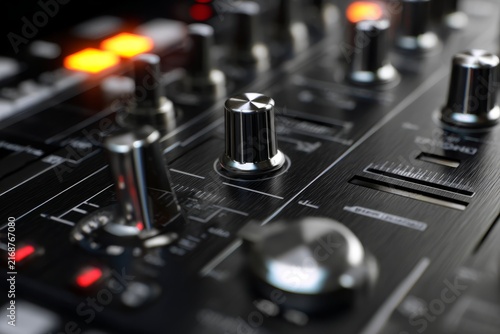 Music festival. concept of electronic music performance. Close-up view of audio mixer control panel with knobs, sliders, and illuminated buttons in dark setting