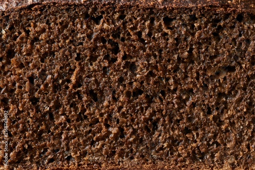 Freshly baked rye bread cut in half showing the dark crumb inside