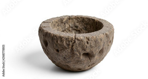 Ancient carved stone bowl, weathered archaeological vessel with cracks, isolated on white background