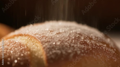 Sparkling sugar dust over pastry warm bakery lighting