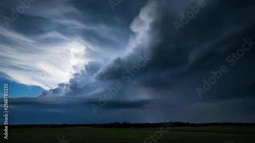 Storm clouds illuminated by frequent lightning flashes