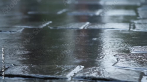 Clean loop of rain hitting wet stone surface
