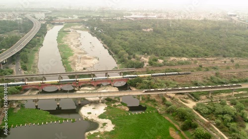 Aerial view of railway bridge and expressway construction in New Delhi, India.