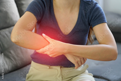 Close Up of Woman Massaging Her Numb Arm to Improve Blood Circulation