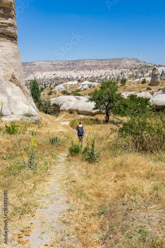 Female hiker explores cappadocia love valley. Concept of summer hiking adventure and freedom.
