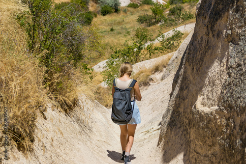 Female hiker explores cappadocia love valley. Concept of summer hiking adventure and freedom.