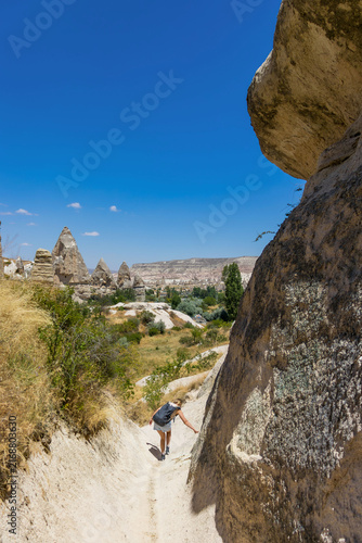 Female hiker explores cappadocia love valley. Concept of summer hiking adventure and freedom.