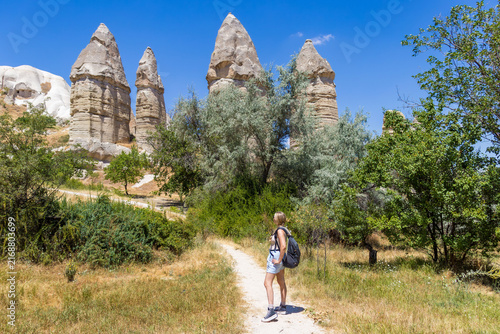 Female hiker explores cappadocia love valley. Concept of summer hiking adventure and freedom.