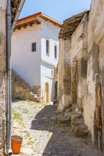 Historic village lane with white stone homes. The scene represents heritage travel, cultural discovery and traditional rural life for tourism appeal