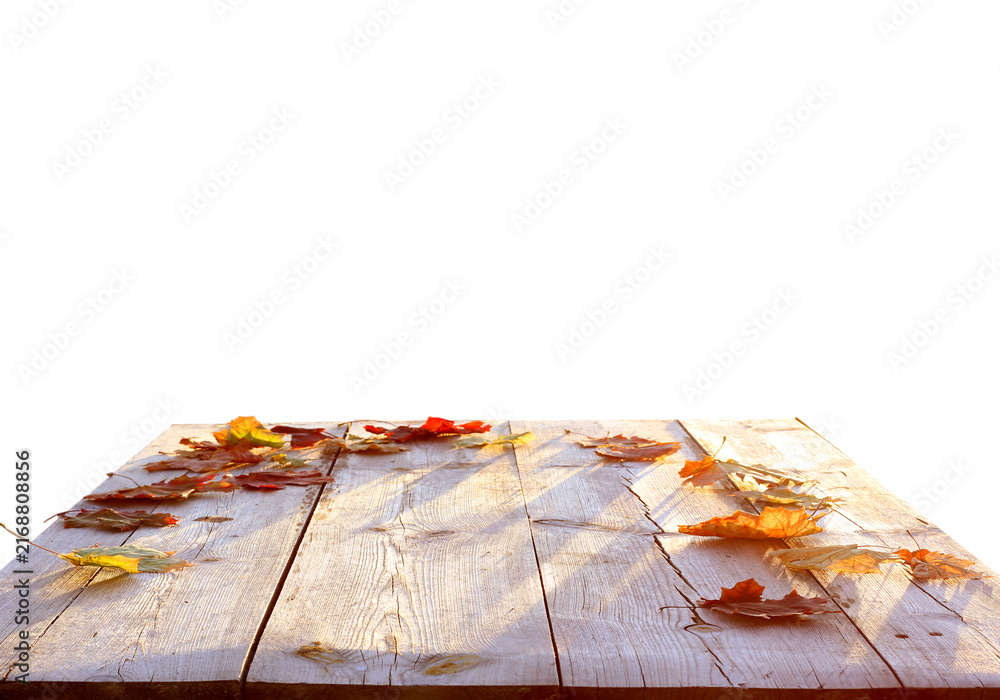 Naklejka premium Autumn Fallen Leaves on a Rustic Wooden Table on transparent background. Light Through the Leaves. Autumn Product podium png 