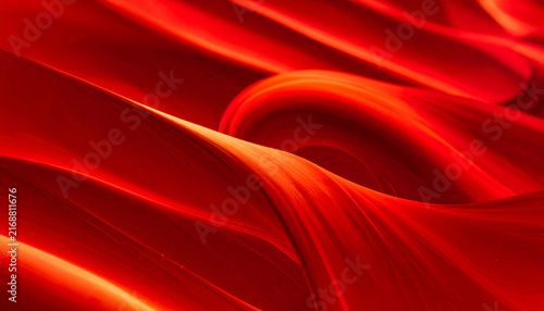 Abstract close-up of flowing crimson red waves background with smooth folds and elegant glowing orange highlights.