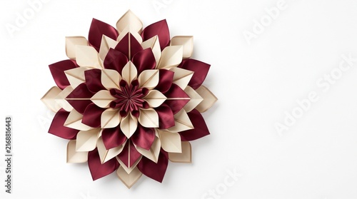 Decorative paper flower mandala with layered burgundy and cream petals isolated on white