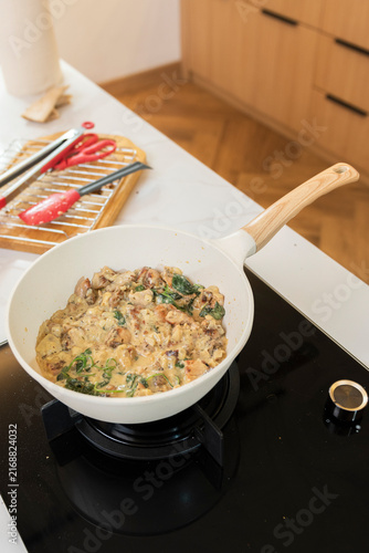 Bild auf Leinwand Finished savory dish served in a bowl after cooking, presented as a homemade meal with a creamy texture and fresh garnish