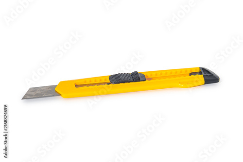 Quadro su tela Yellow stationery knife with retractable blade isolated on white background