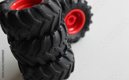 Toy tractor wheels with mud tires one on another studio isolated
