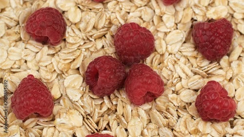 Oatmeal with raspberries close up, rotation. Healthy vegan breakfast concept