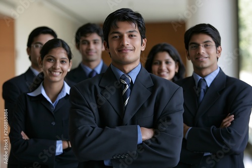 Group of confident indian business people smiling with arms crossed in office lobby