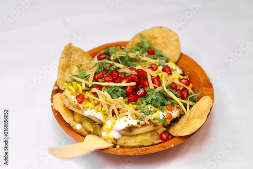Fotografie Papdi chaat on white background served in an earthen plate