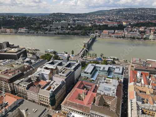 Aerial view of Budapest cityscape with Chain Bridge, Danube River, and Buda Castle under cloudy sky