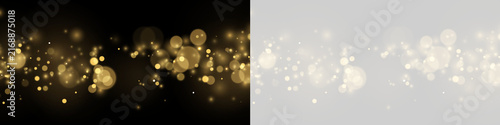 A horizontal stream of golden bokeh lights floats across a dark background. The glowing orbs vary in size, density, and intensity with soft edges and shimmering highlights.
