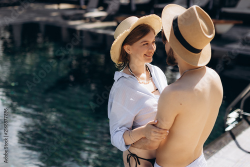 Konstfotografi Romantic couple enjoying summer vacation by swimming pool