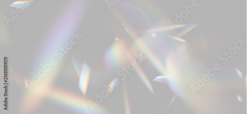 Prismatic light refractions scatter vivid rainbow colors against a dark background. Iridescent beams display soft gradients and sharp edges in multiple directions.